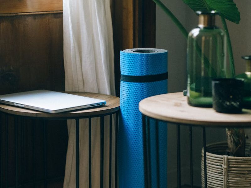 A spacious, minimalist room with a yoga mat on the floor.